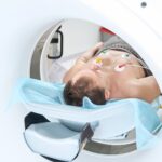 Patient is undergoing contrast-enhanced ECG-gated coronary CT angiography